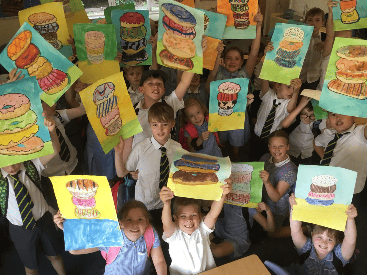 Gorsey Bank Year 4 pupils hold up colourful paintings of donuts
