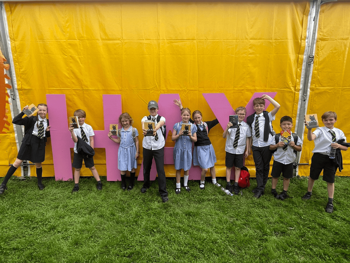 Gorsey Bank's Department for Education Pupils pose with a HAY sign at the Hay Festival