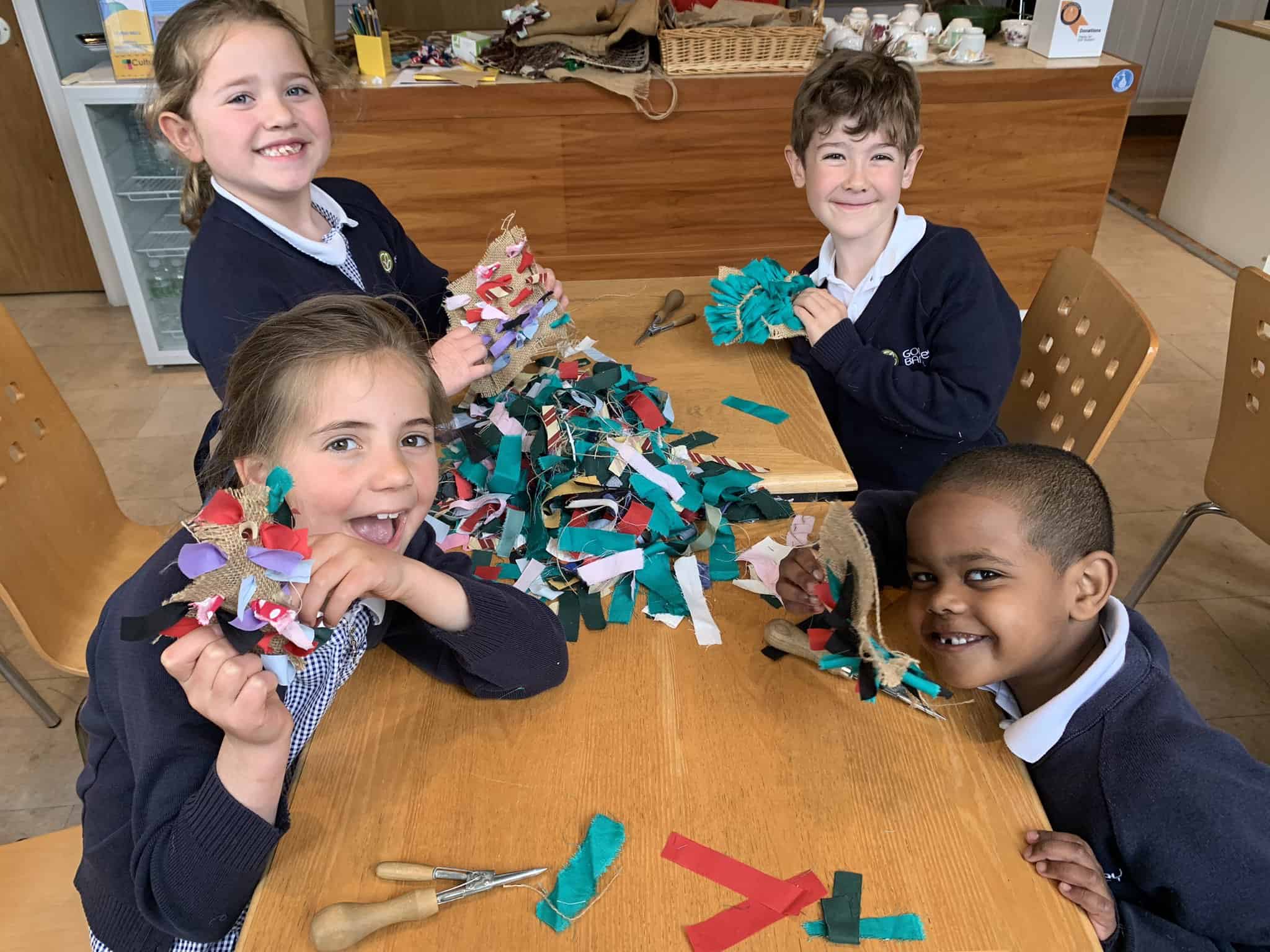 Year 2 pupils from Gorsey Bank pose with their rug crafts.