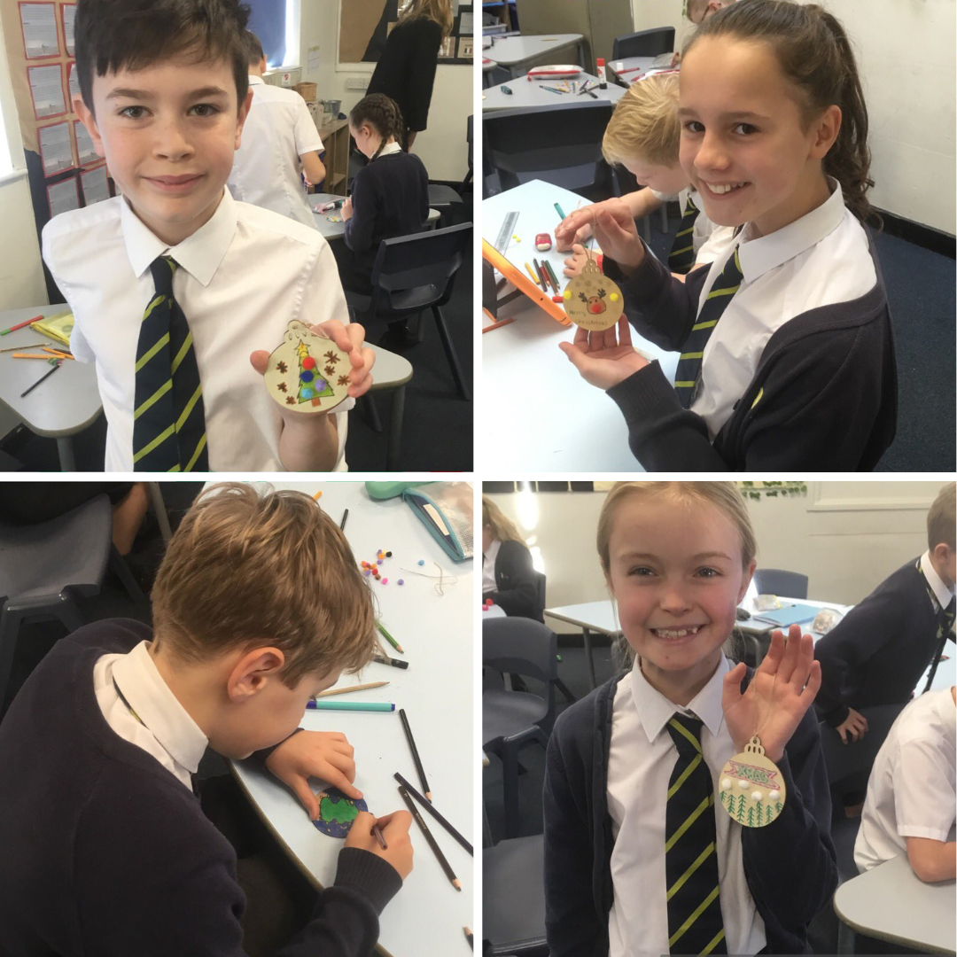 pupils in year 6 pose with their Christmas creations