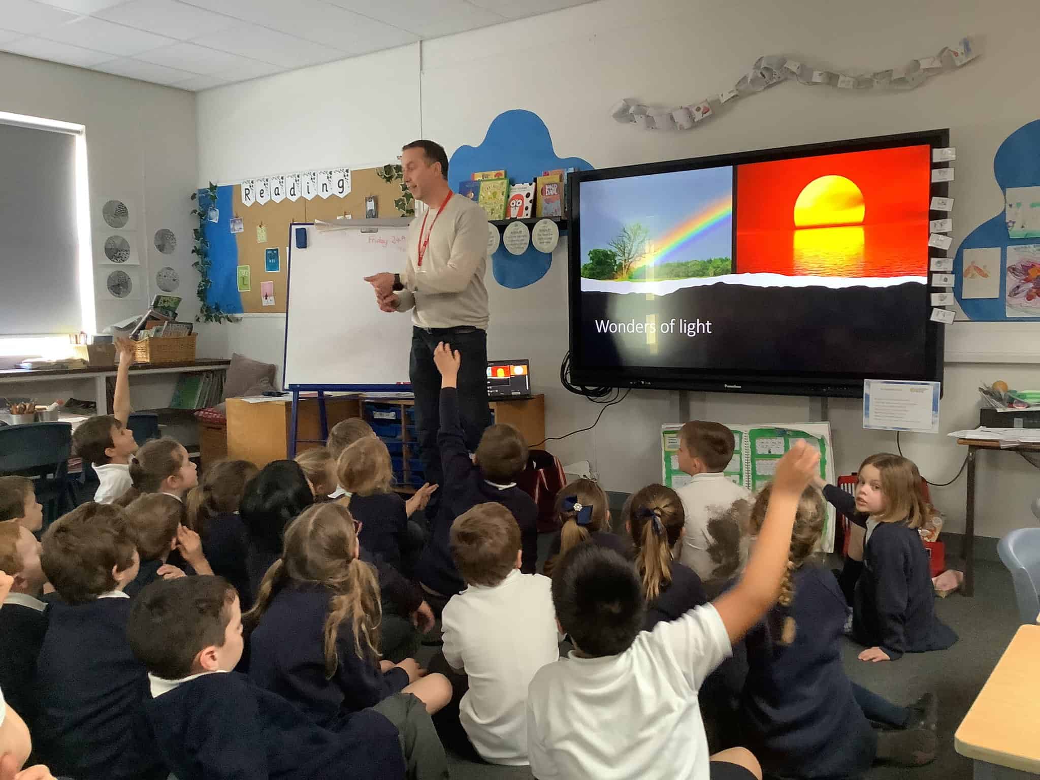 A scientist speaks to a class of Year 2 pupils from Gorsey Bank